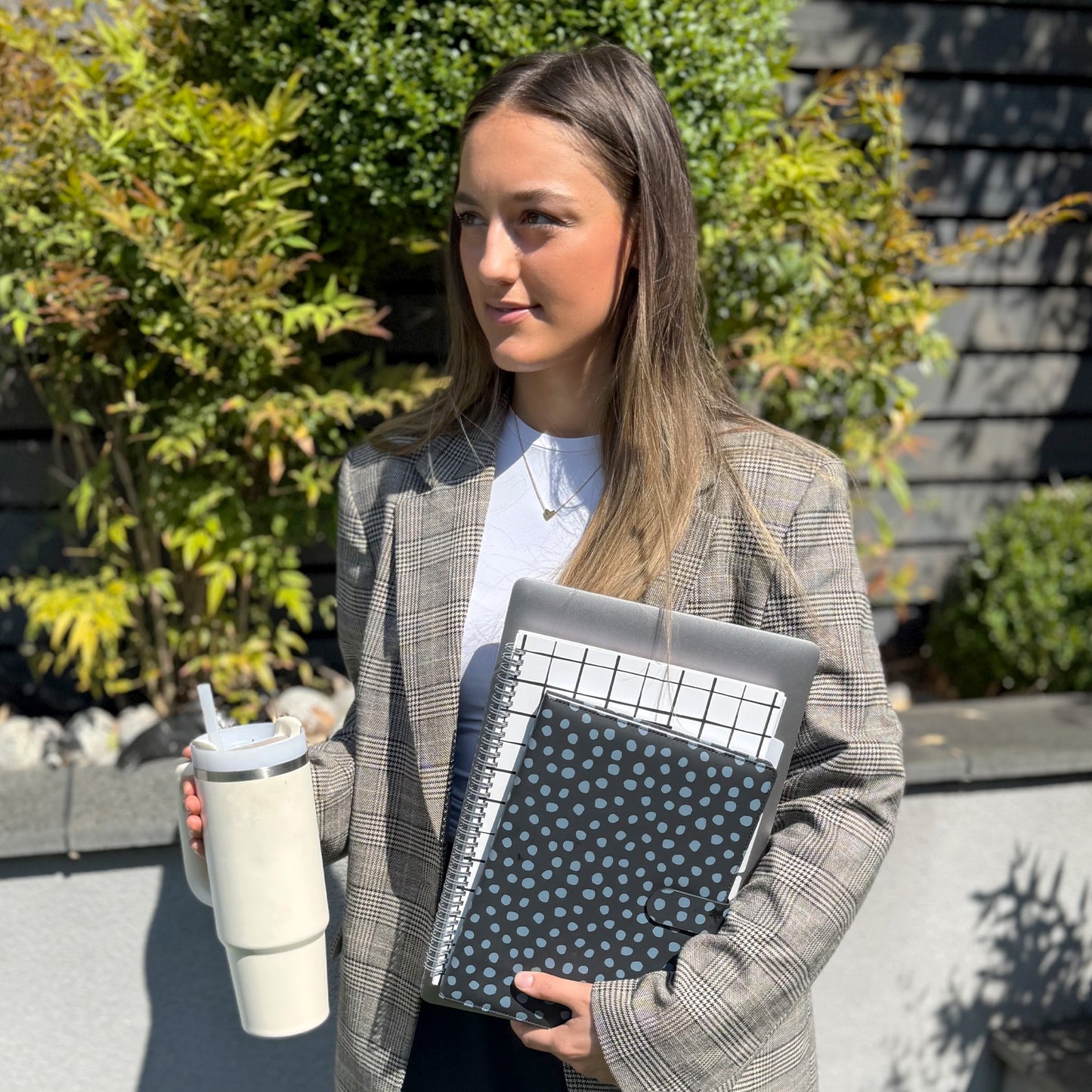 Student holding note books at college for taking her notes and revision notes