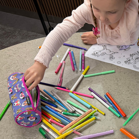Dog pencil case with girl showing pencils and pens in stationery case 